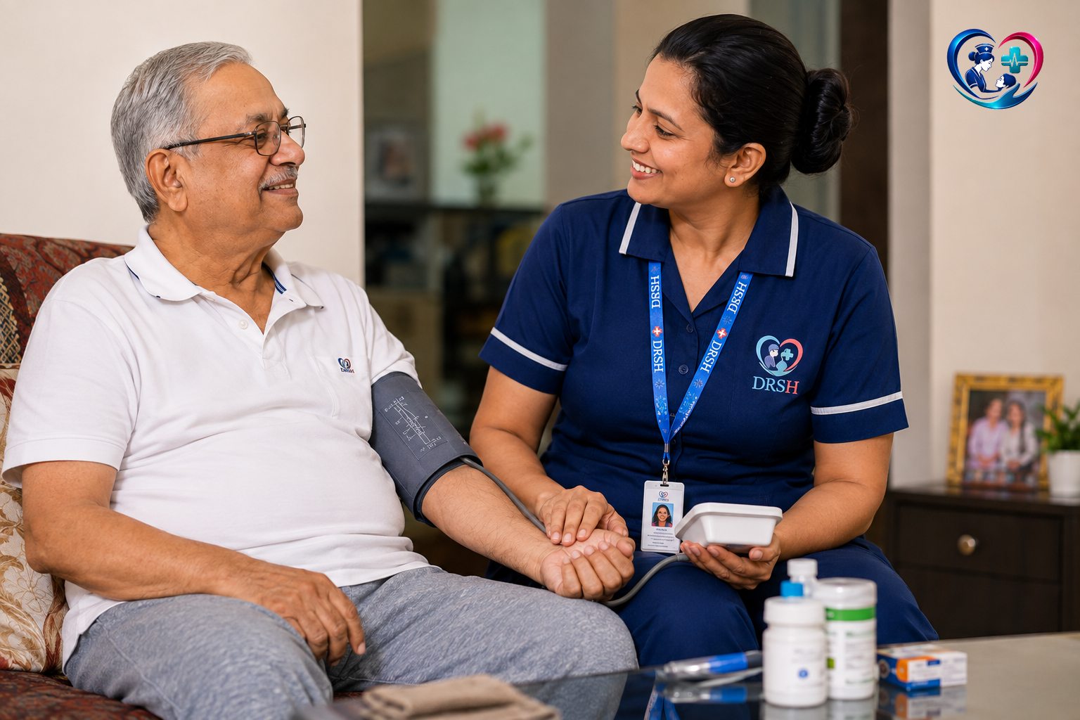 A DRSH nurse checking an elderly man's blood pressure at home in Pune